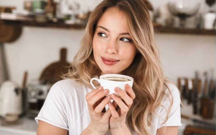 donna che beve tazza di caffè 
